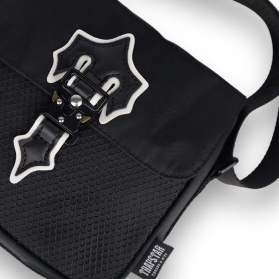 Trapstar black and white Irongate T cross-body bag with adjustable strap and sleek design on a neutral background.