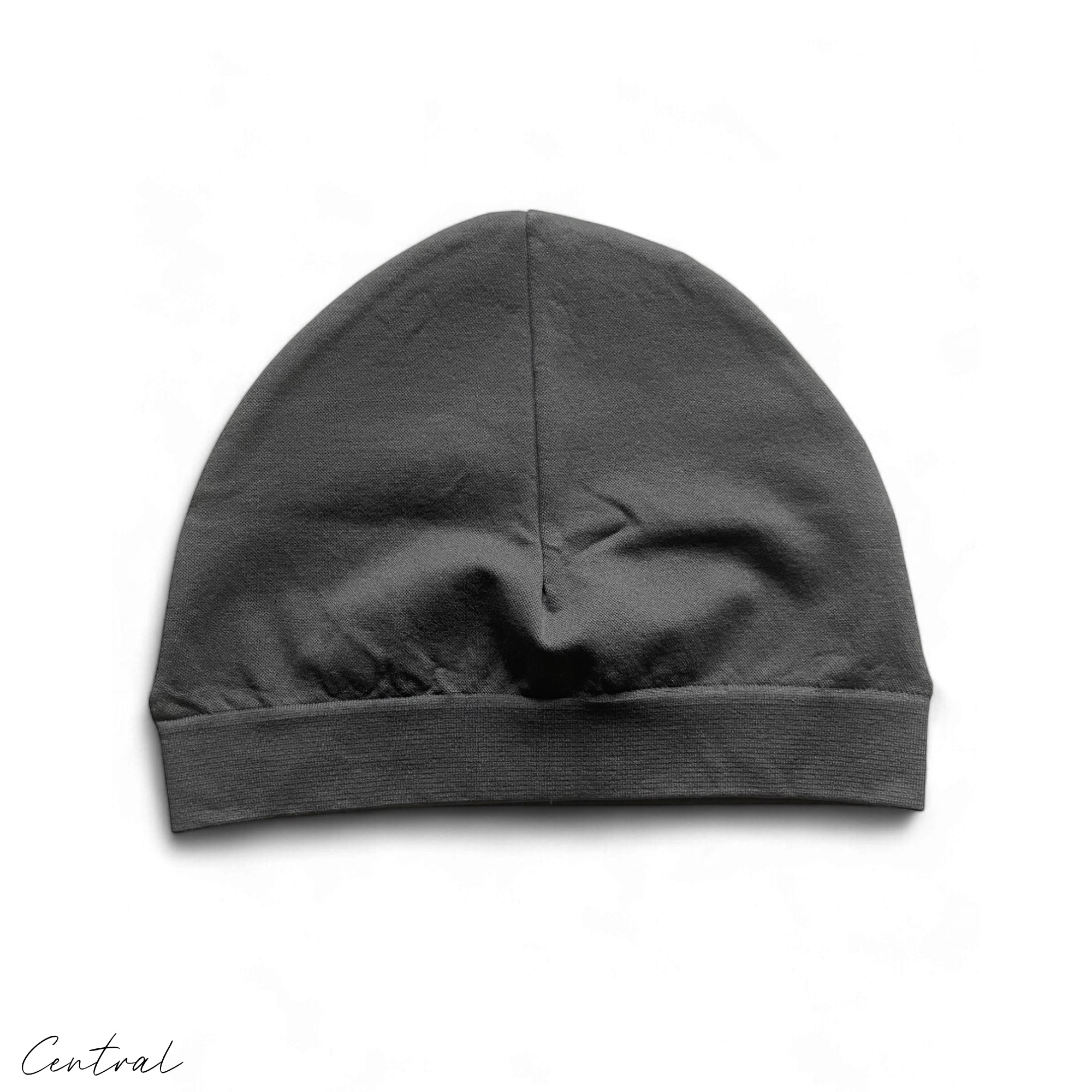 Central ae gray and green Syna skull cap beanie displayed on a neutral background, showcasing its stylish design.