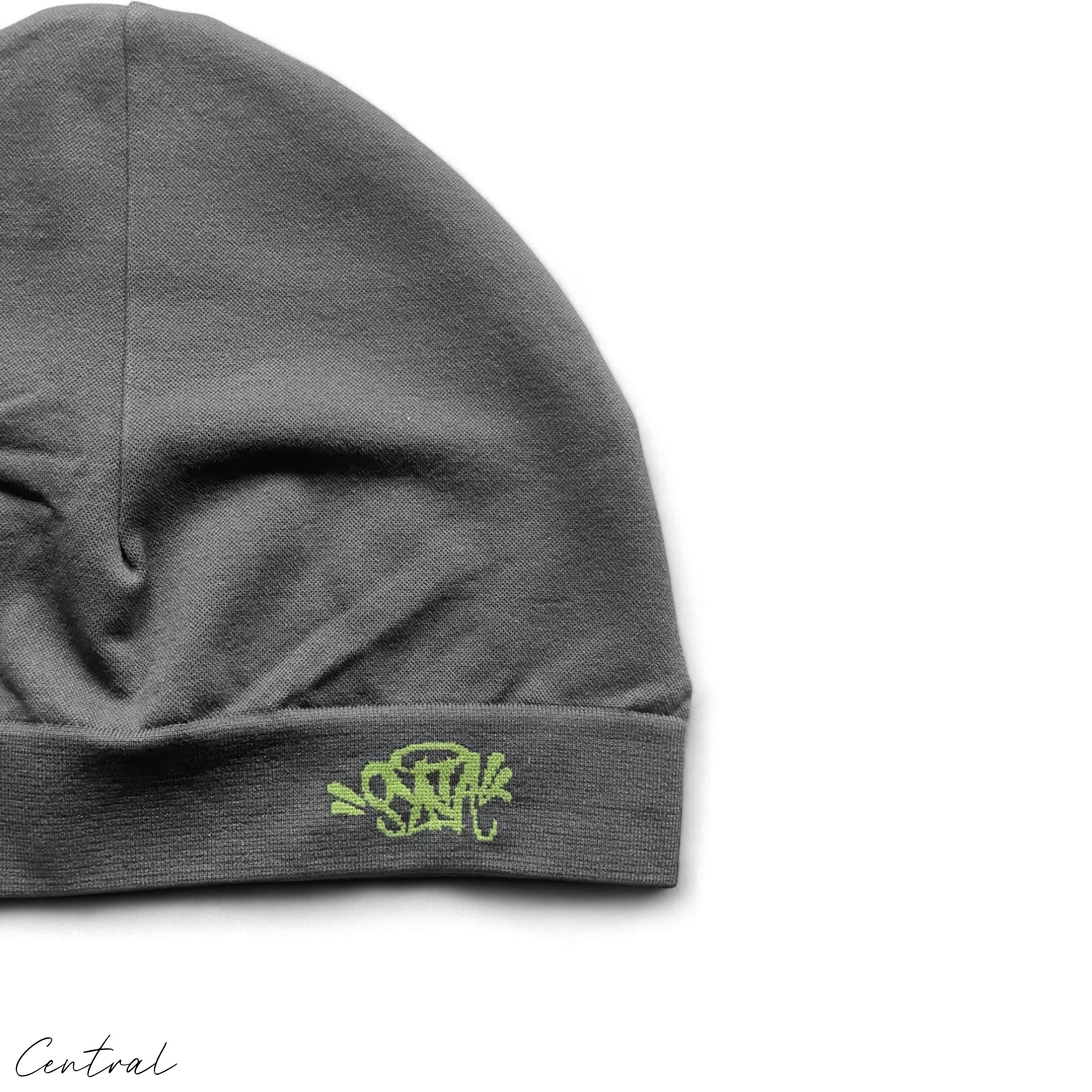 Gray and green Syna Skull Cap beanie by Central ae, featuring a snug fit and stylish design.