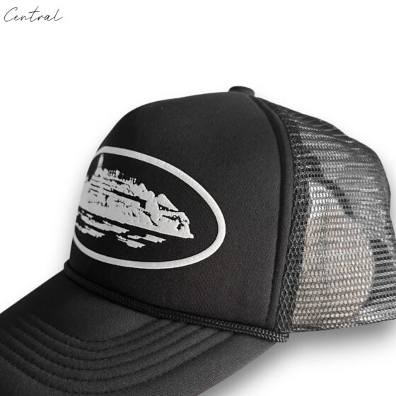Black Corteiz cap by Central ae displayed with a curved brim and adjustable strap, showcasing a sleek, modern design.