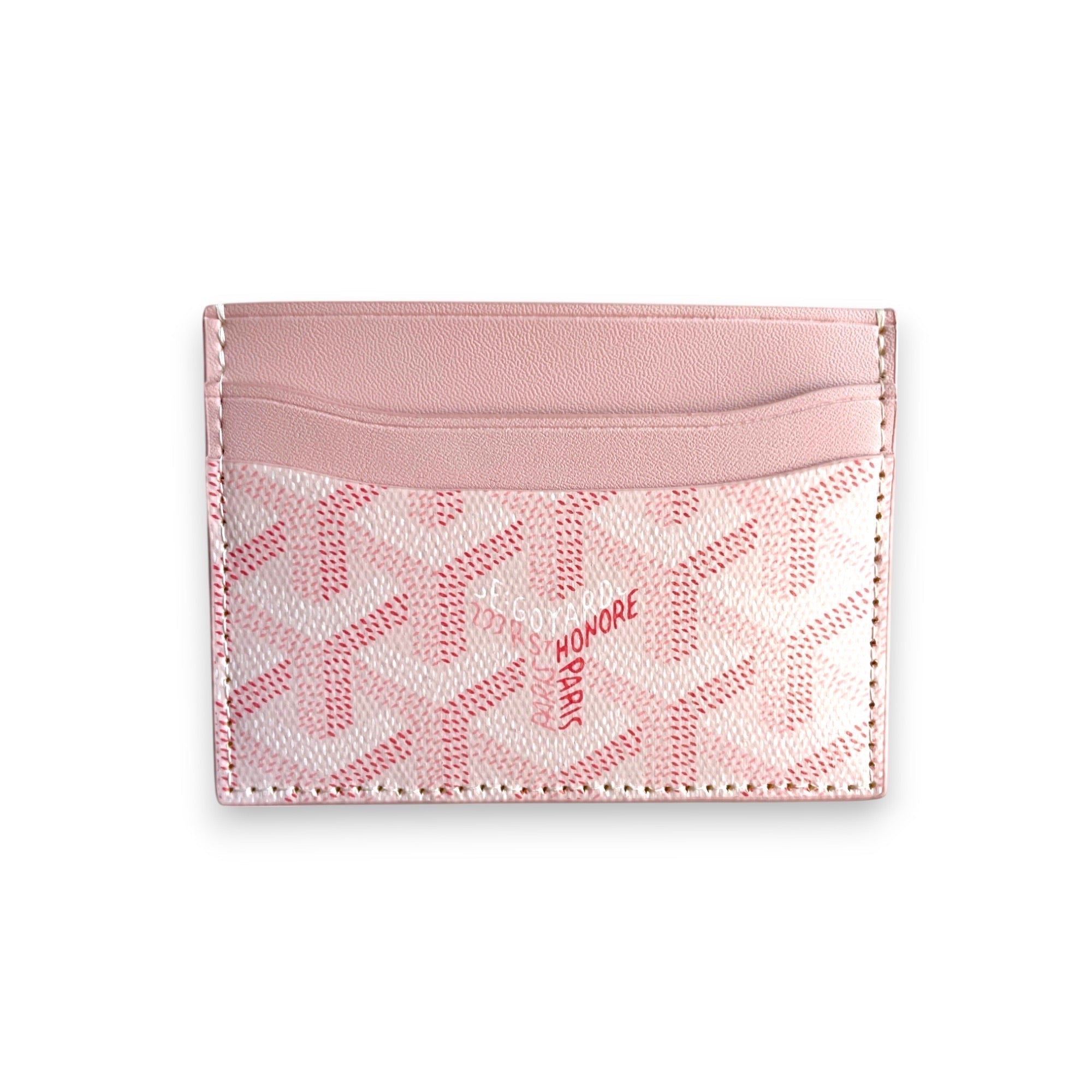 Pink Goyard card holder by Central ae, featuring a sleek design and signature pattern on a textured surface.