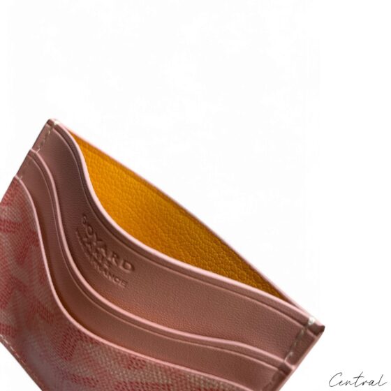 Pink Goyard card holder featuring the brand's signature pattern and sleek design, ideal for storing cards and cash.