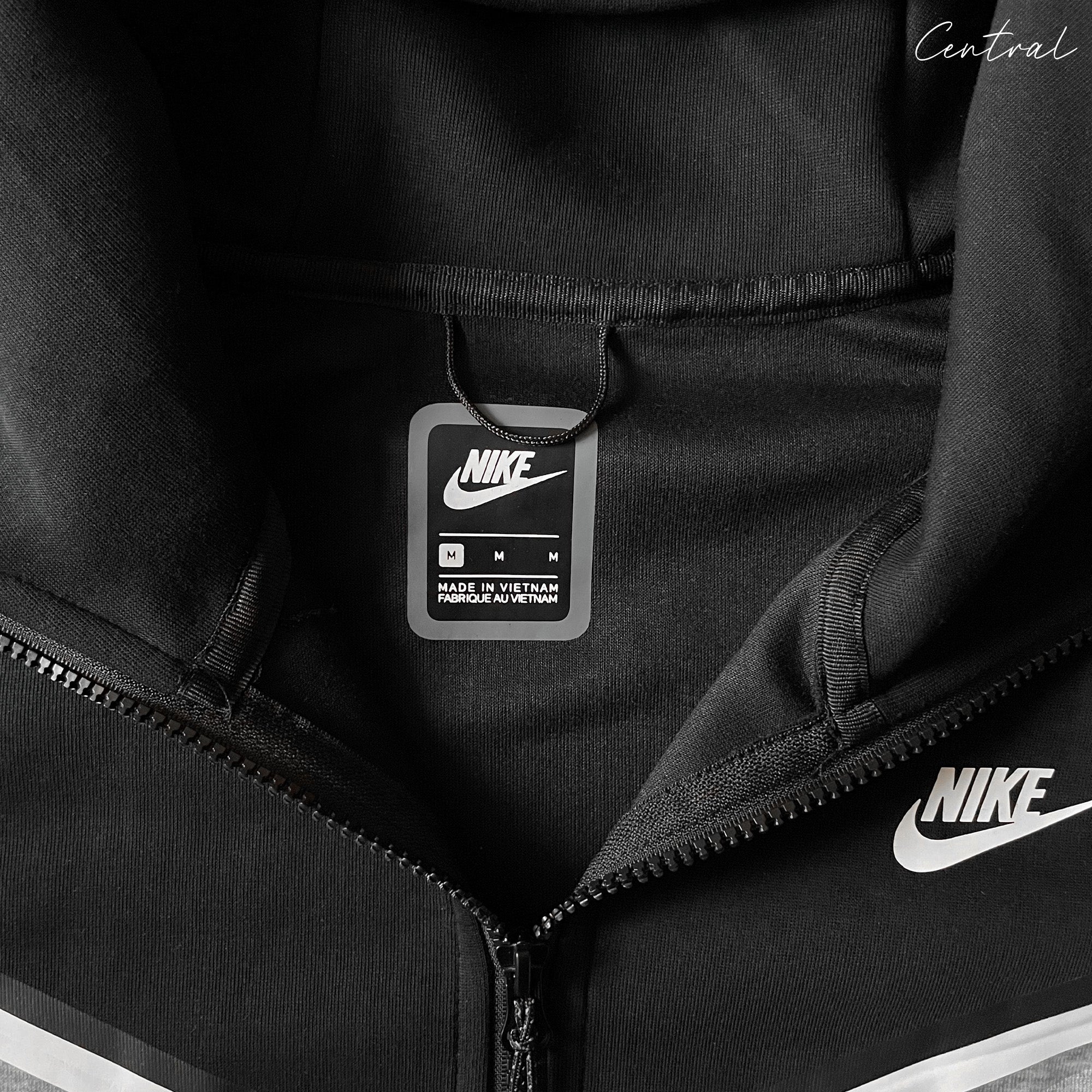 Nike Tech Fleece tracksuit in grey and black, featuring a comfortable hoodie and matching pants set.