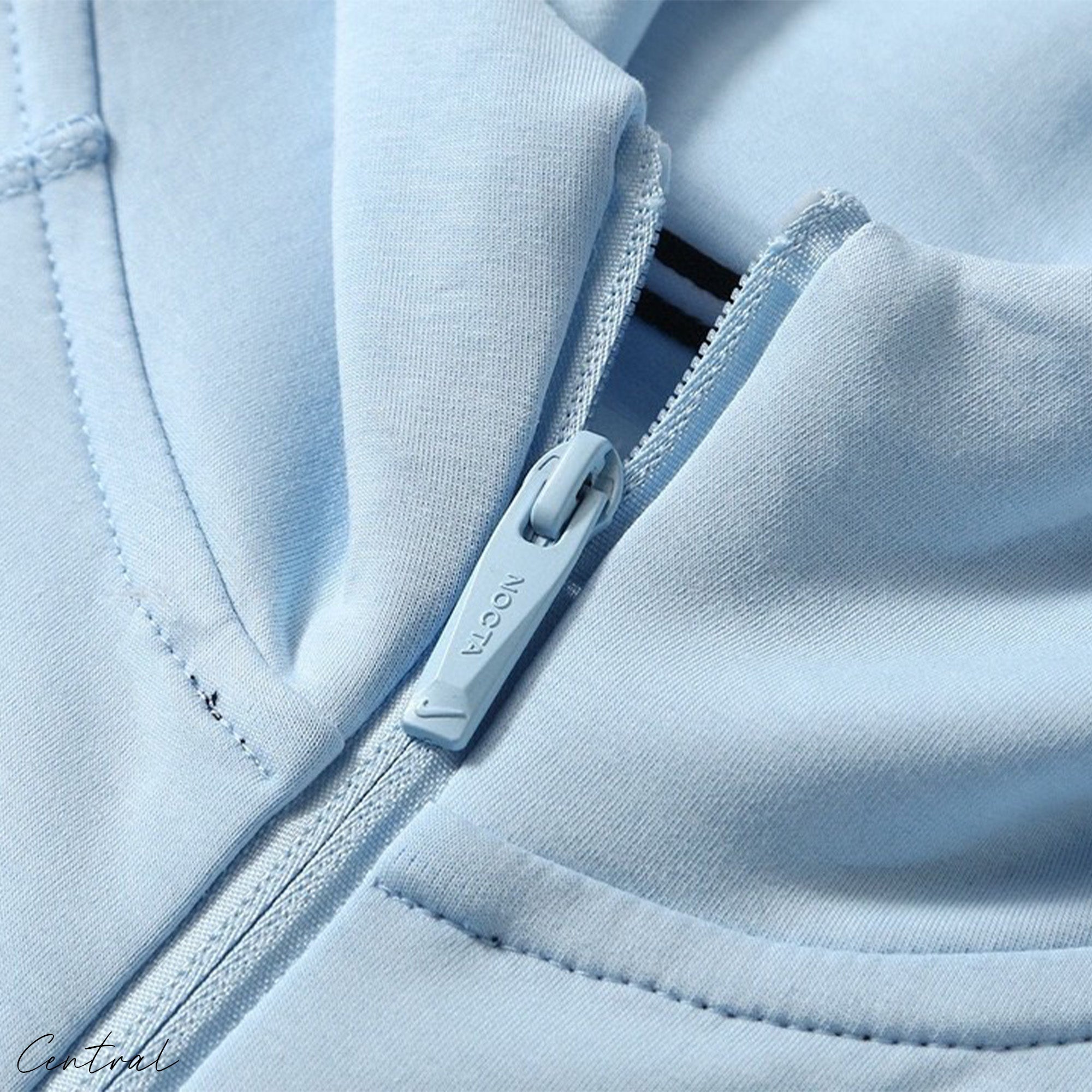 Central ae NOCTA Tech Fleece hoodie and pants set in a sleek design, showcasing fabric texture and comfortable fit.