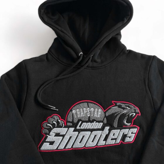 Trapstar Shooters black-red tracksuit featuring a stylish hoodie and matching pants set.