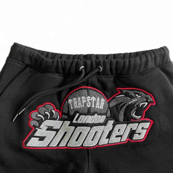 Trapstar Shooters black-red tracksuit set featuring a hoodie and pants, designed for a stylish, sporty look.