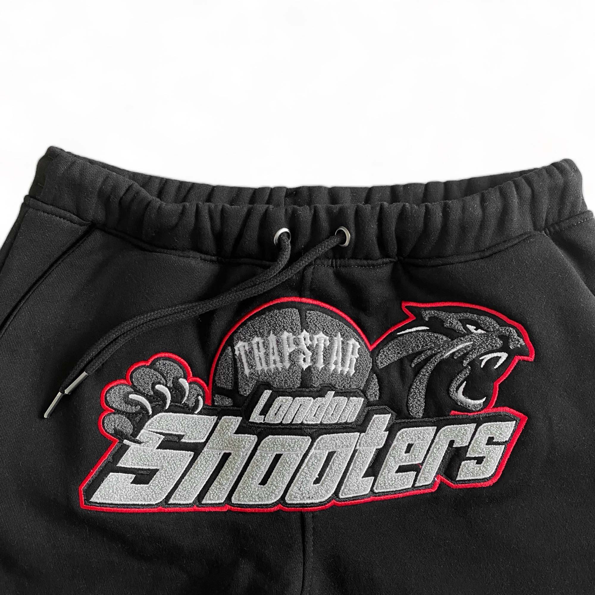 Trapstar Shooters black-red tracksuit set featuring a hoodie and pants, designed for a stylish, sporty look.