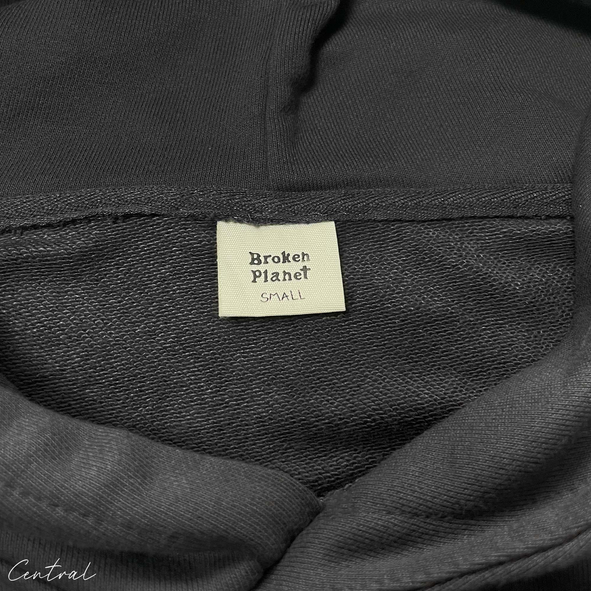 Central ae Broken Planet Out of the Shadows hoodie in dark color with graphic design on front and relaxed fit.