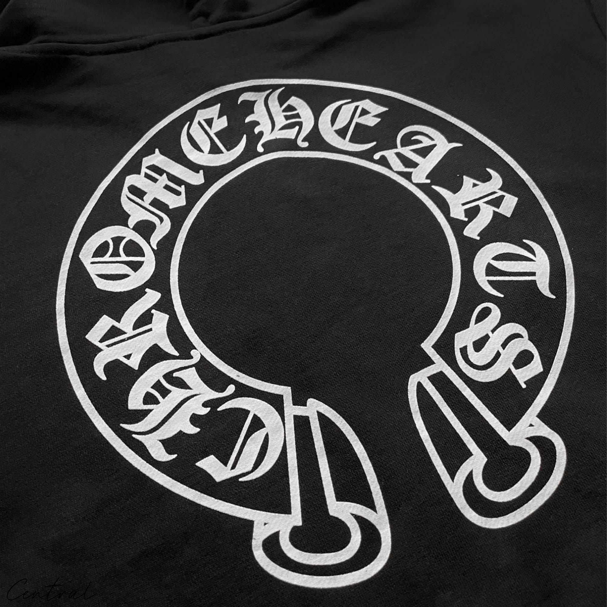 Chrome Hearts Horseshoe Zip Up Hoodie by Central ae in black with distinctive logo detailing and stylish zip closure.