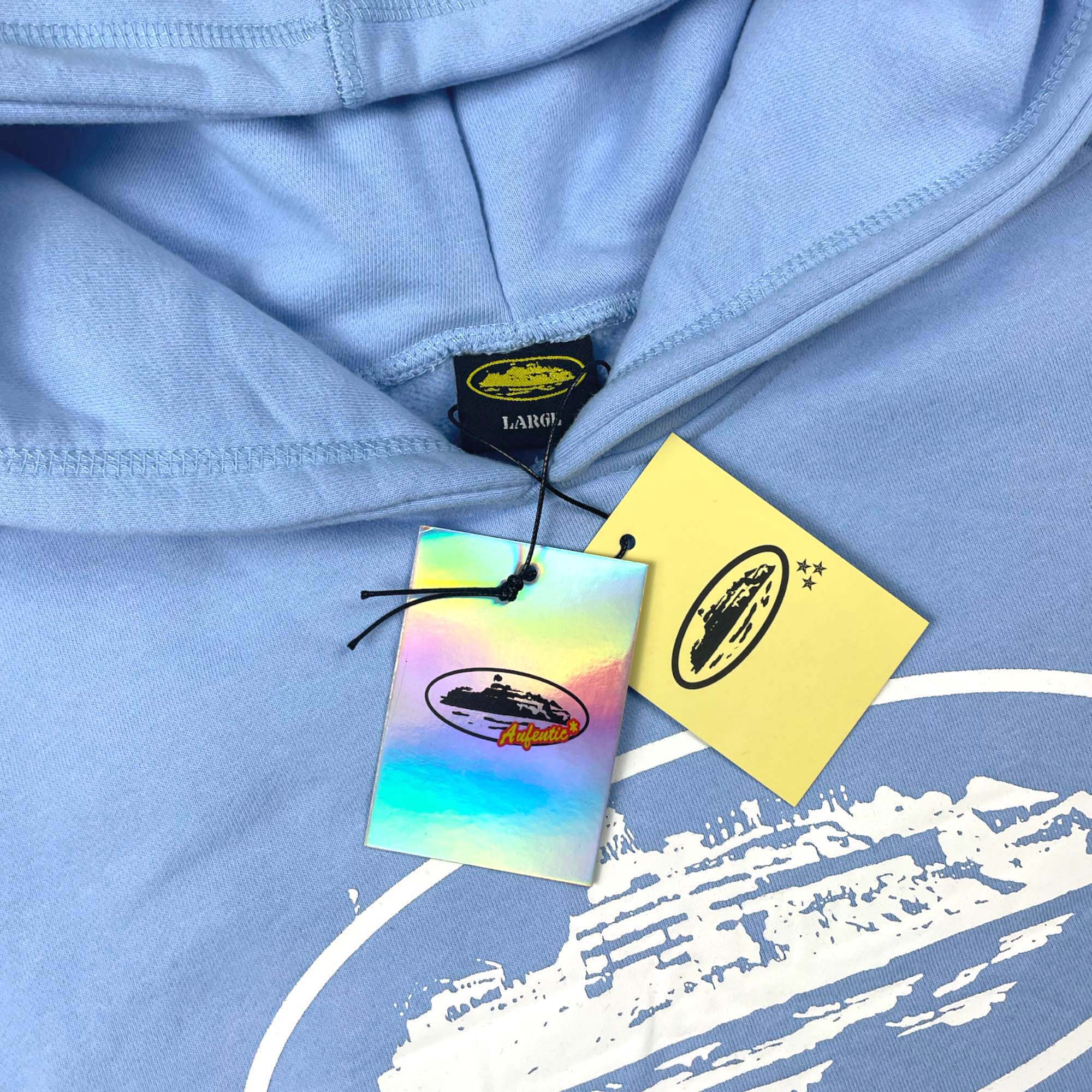 Corteiz Alcatraz Hoodie in baby blue displaying a cozy design with a front pocket and adjustable drawstring hood.