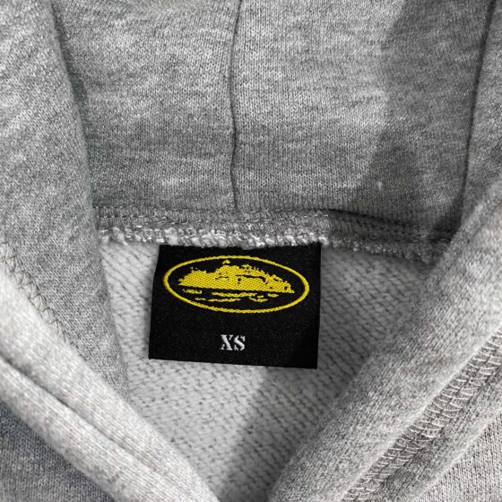 Grey Corteiz Alcatraz Hoodie featuring a relaxed fit and logo design, perfect for casual wear and street style.