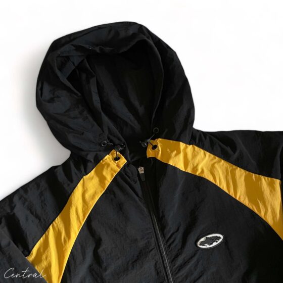 Black and yellow Corteiz hoodie featuring a stylish spring design by Central ae, displayed on a neutral background.