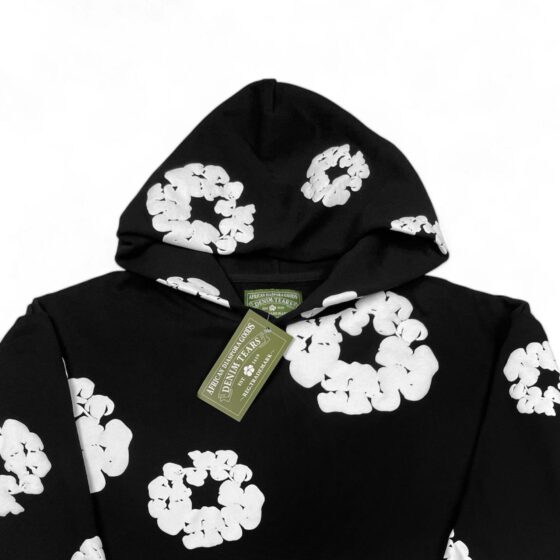Black hoodie from Central AE featuring the Denim Tears cotton wreath design on the front.