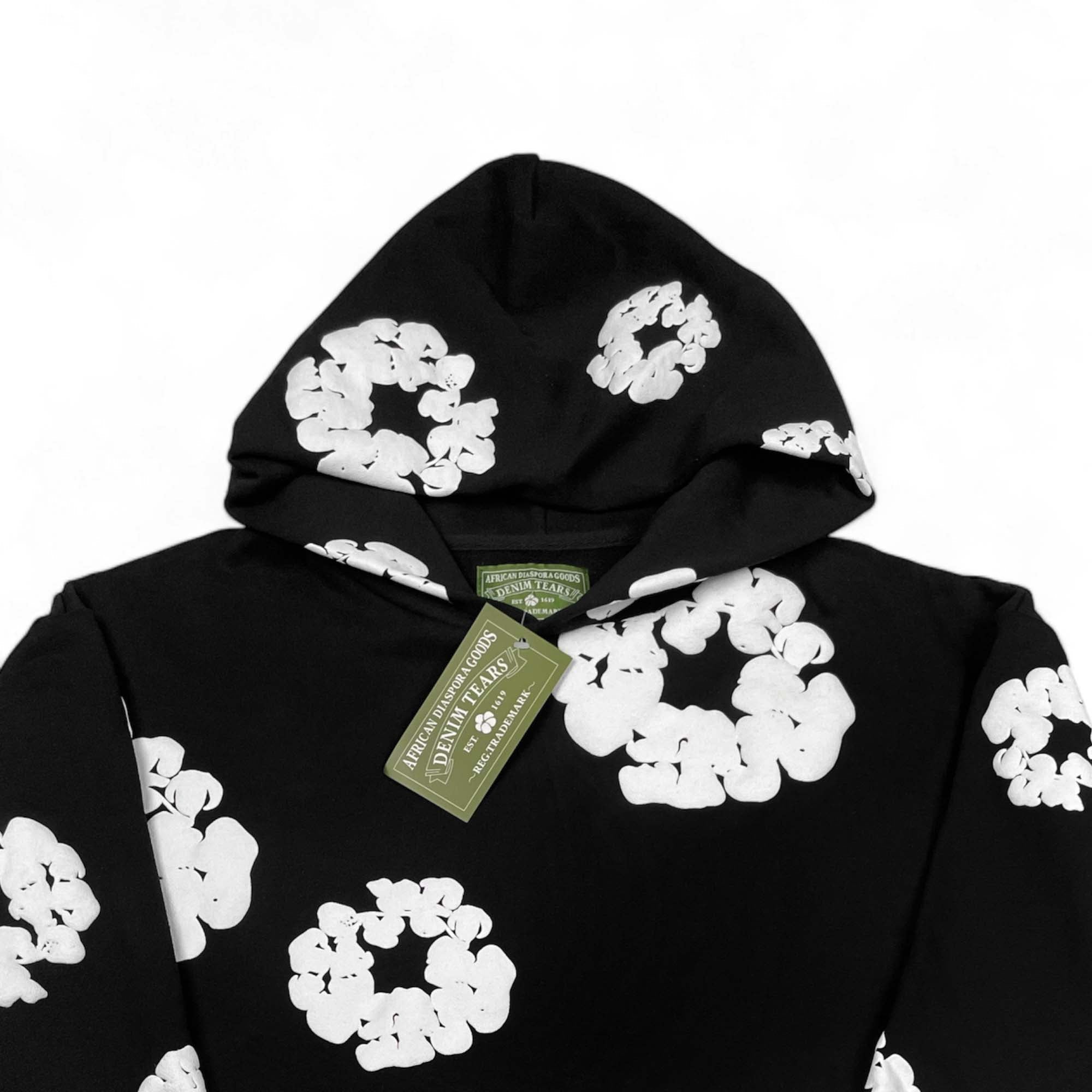 Black hoodie from Central AE featuring the Denim Tears cotton wreath design on the front.