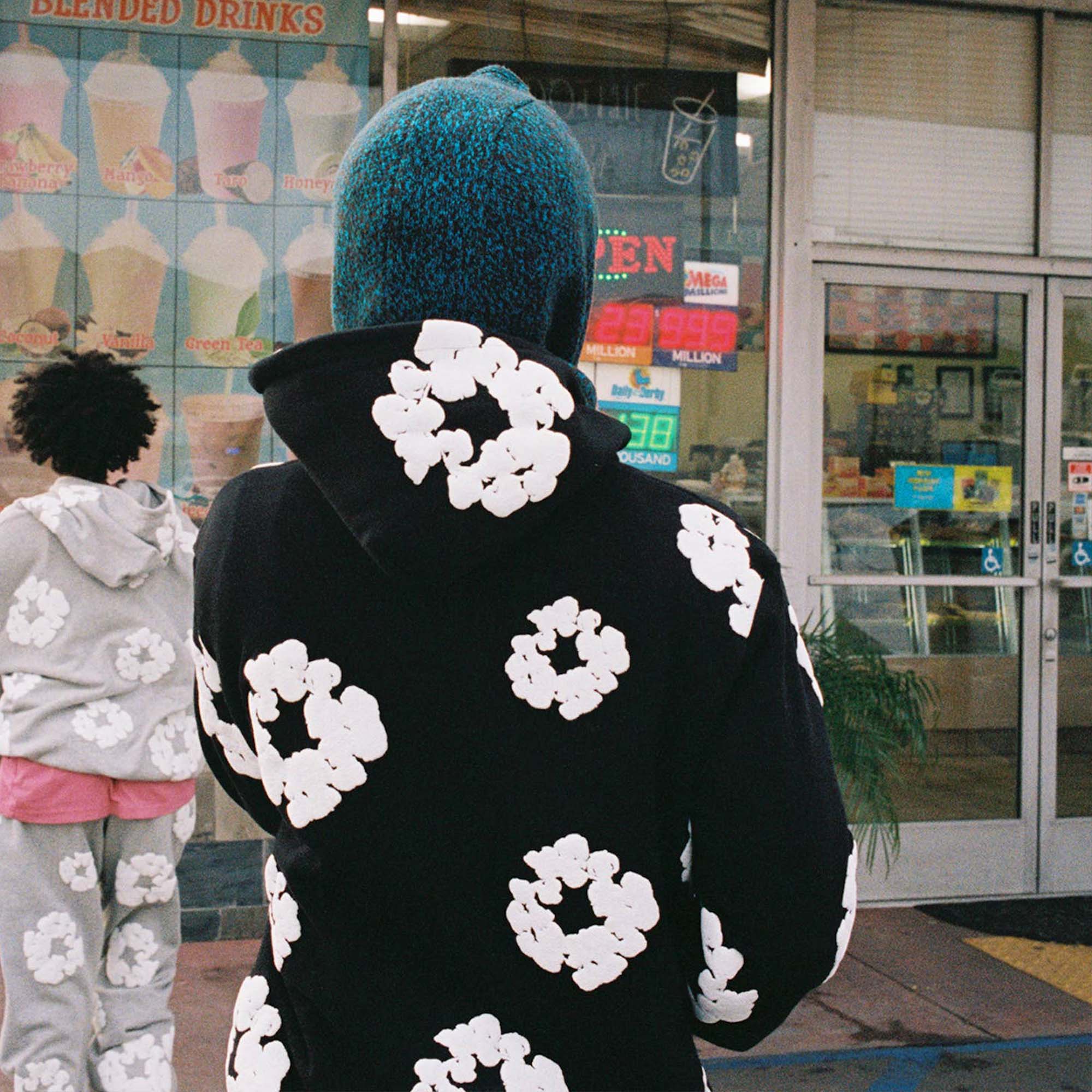 Black hoodie from Central AE featuring a unique cotton wreath design by Denim Tears.