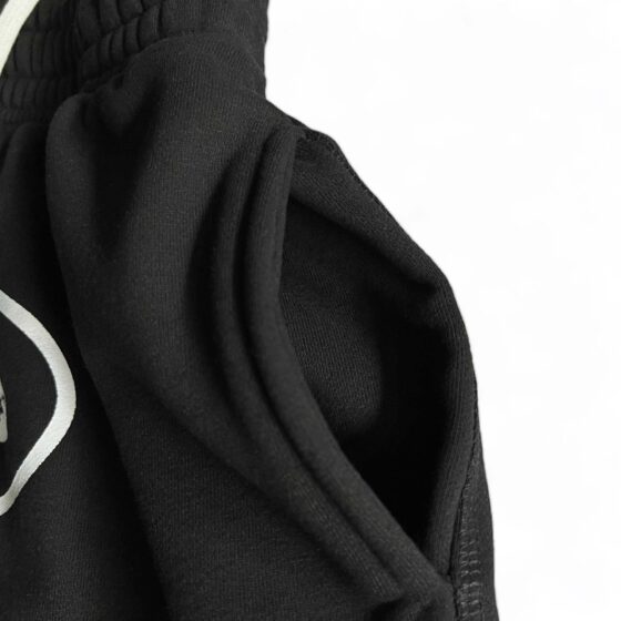 Black Corteiz Alcatraz sweatpants featuring a relaxed fit and elastic waistband, perfect for casual wear.