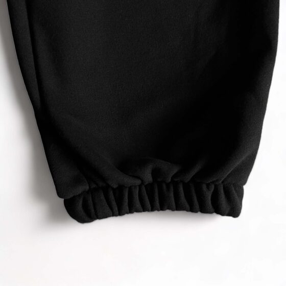 Black Corteiz Alcatraz sweatpants featuring a relaxed fit and elastic waistband, perfect for casual wear.
