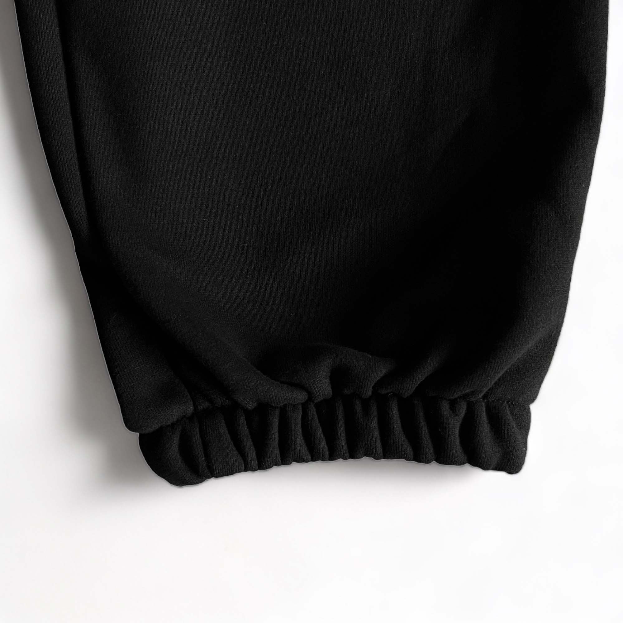 Black Corteiz Alcatraz sweatpants featuring a relaxed fit and elastic waistband, perfect for casual wear.