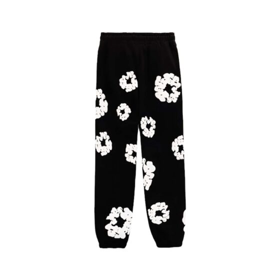 Black sweatpants featuring a cotton wreath design by Denim Tears, showcasing a relaxed fit and soft fabric.