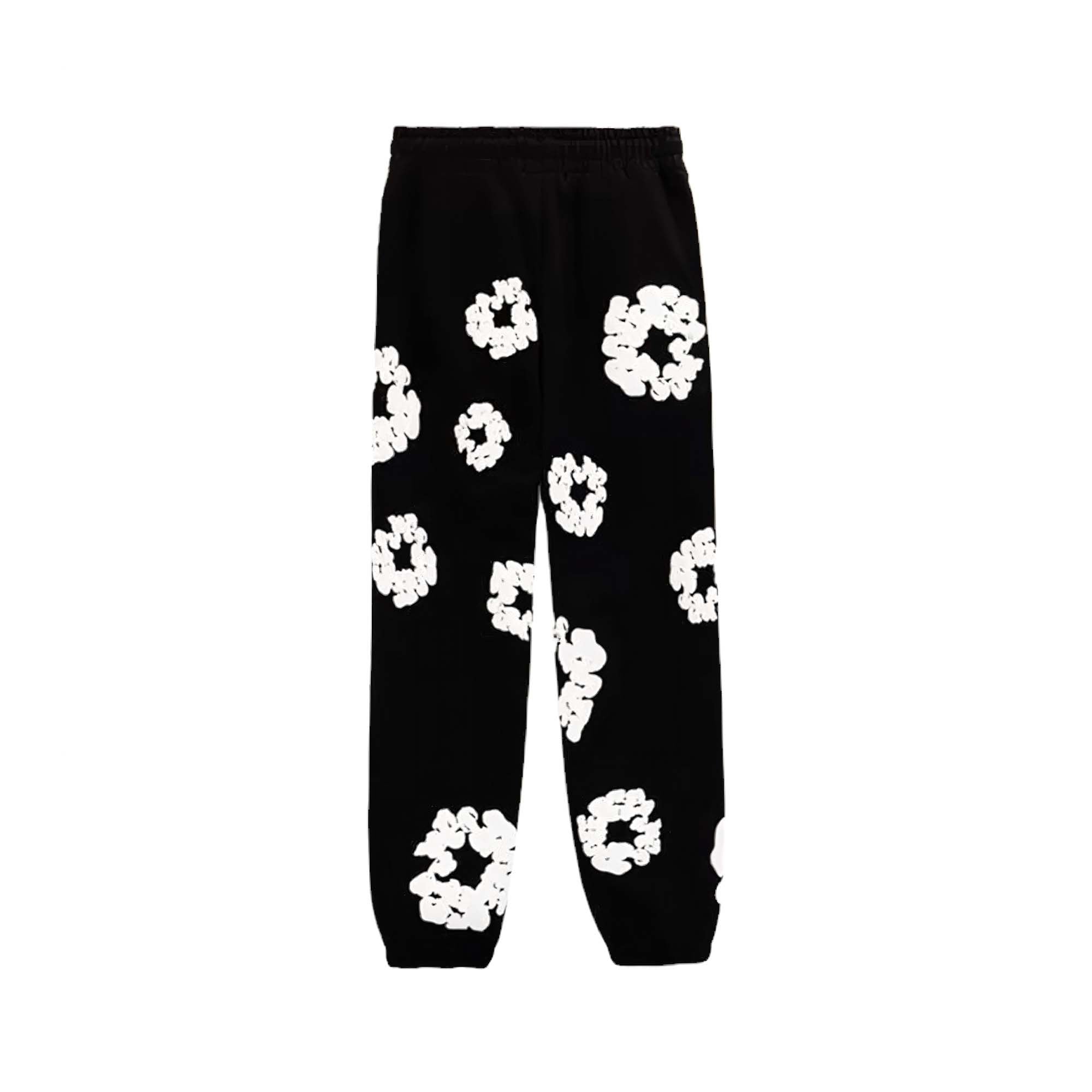 Black sweatpants featuring a cotton wreath design by Denim Tears, showcasing a relaxed fit and soft fabric.