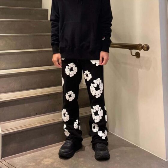 Black sweatpants by Central AE featuring a unique cotton wreath design for a stylish and comfortable fit.