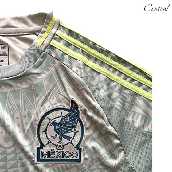 Mexico 2024/25 Away Fan version jersey featuring team colors and logo, displayed on a mannequin with a sporty backdrop.