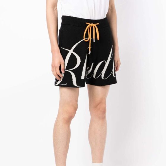 Black and creme Rhude knit logo shorts featuring a relaxed fit and elastic waistband by Central ae.