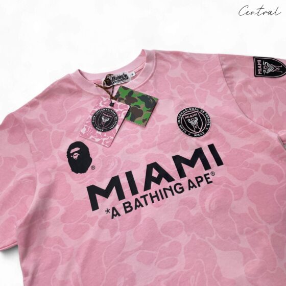 BAPE x Inter Miami pink camo t-shirt featuring a vibrant design and relaxed fit by Central ae.