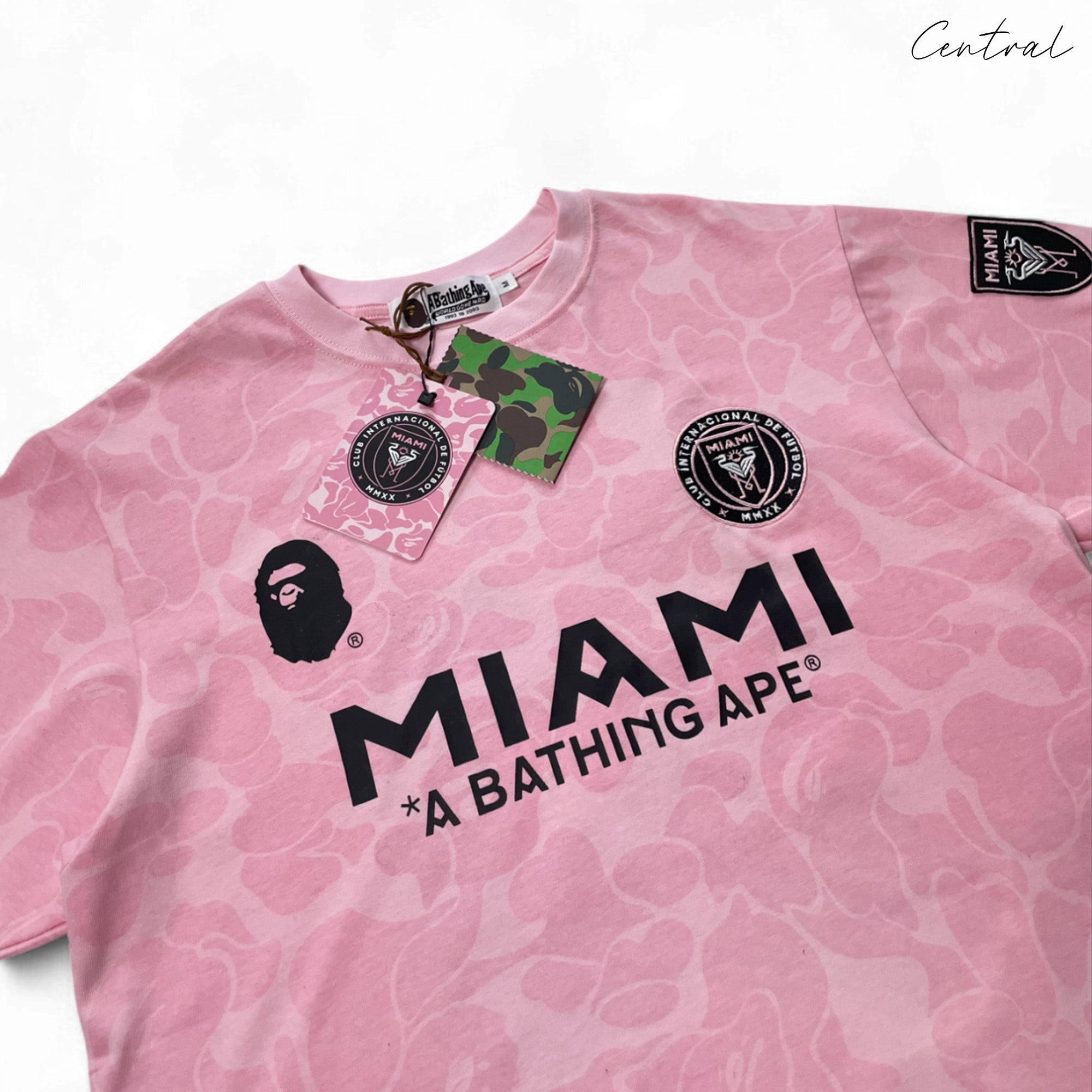 BAPE x Inter Miami pink camo t-shirt featuring a vibrant design and relaxed fit by Central ae.