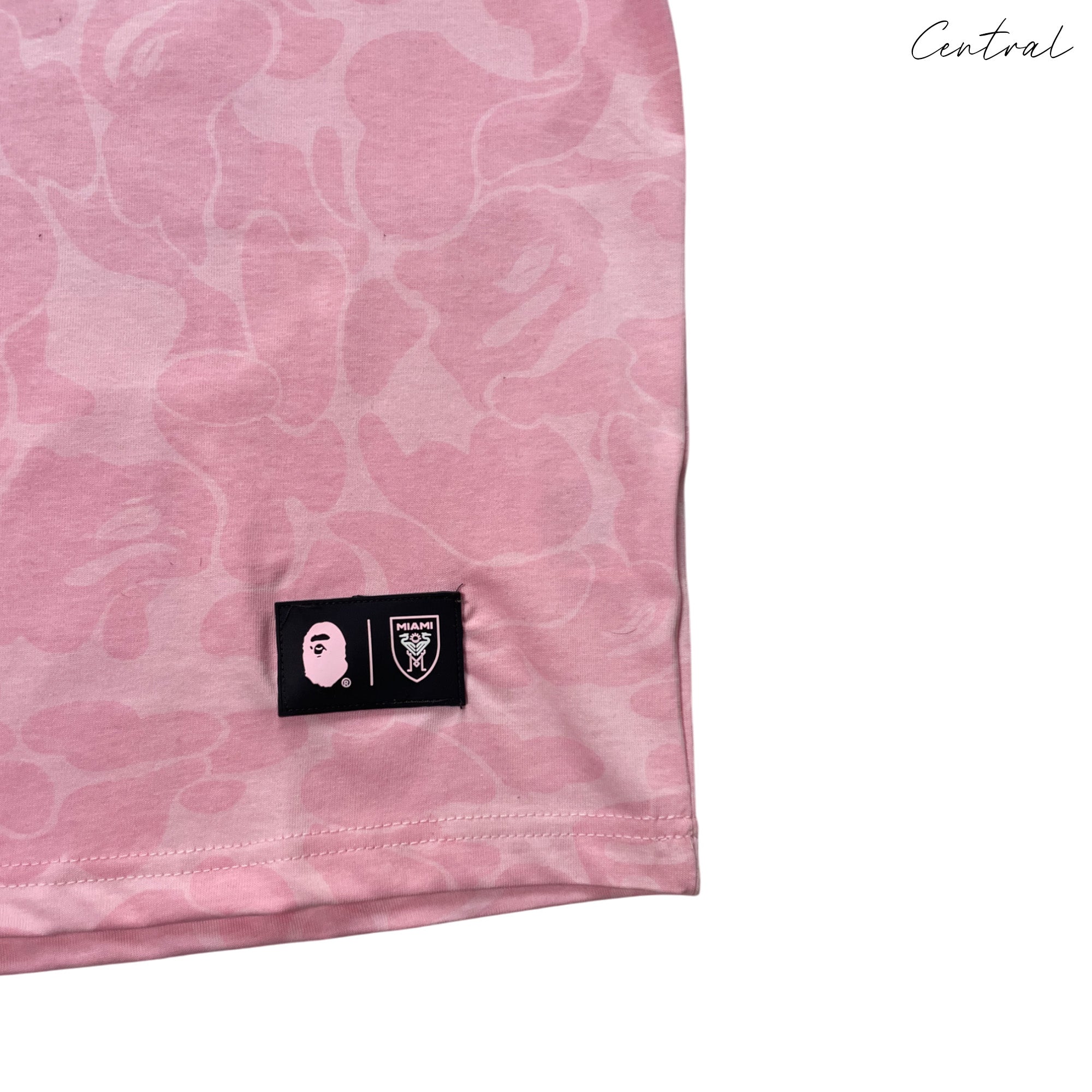 BAPE x Inter Miami pink camo t-shirt by Central ae, featuring a vibrant camouflage pattern and crew neckline.