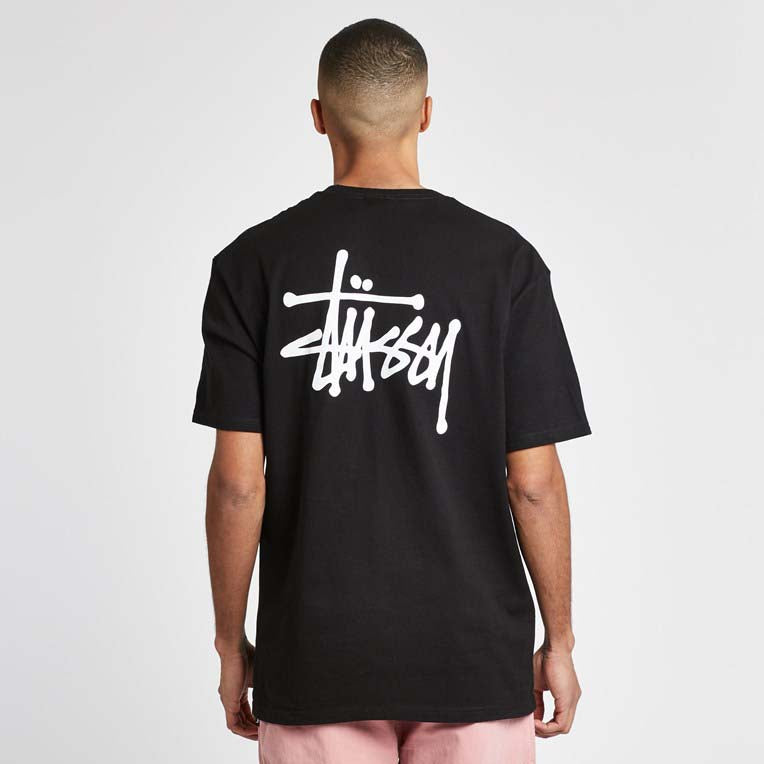 Black basic Stüssy tee featuring a classic crew neck and relaxed fit, displayed on a neutral background.