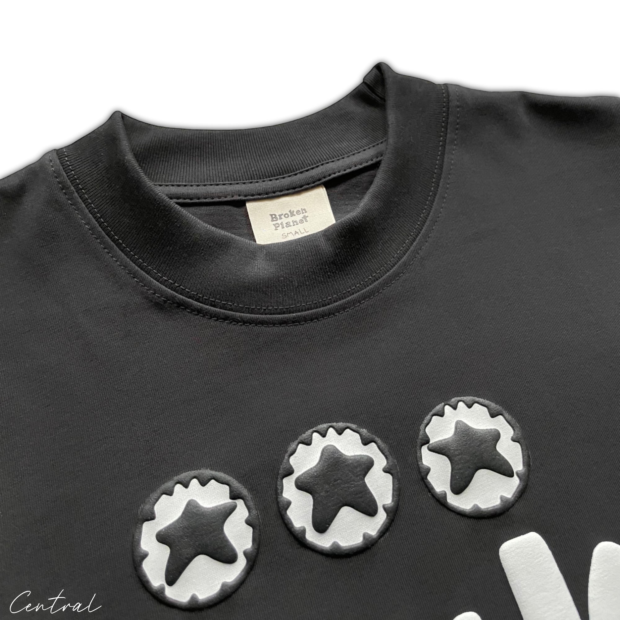 Black Broken Planet Total Chaos T-shirt by Central ae featuring a bold graphic design on the front.