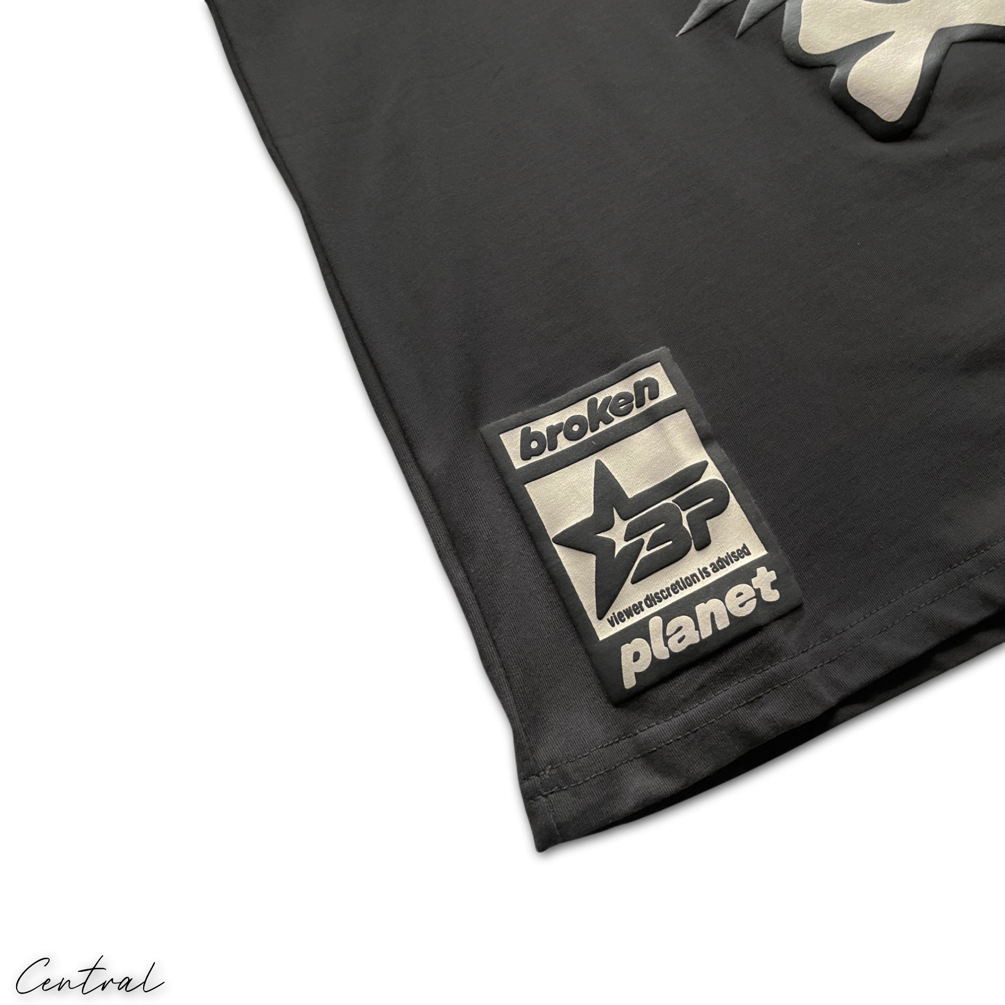 Central ae Broken Planet Total Chaos T-shirt featuring a vibrant graphic design on a casual black tee.