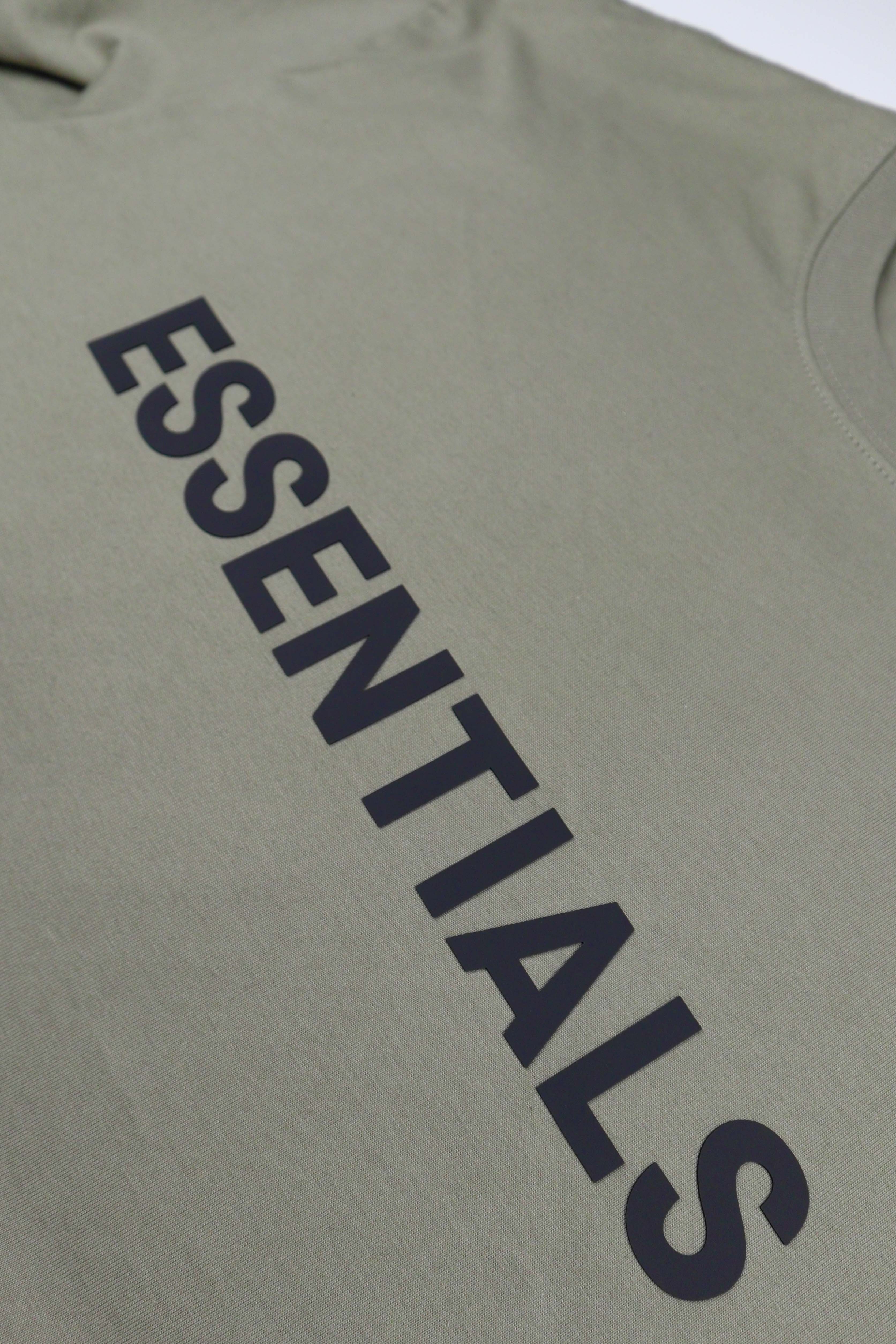 Olive green oversized FOG ESSENTIALS t-shirt laid flat, showcasing its soft fabric and relaxed fit.