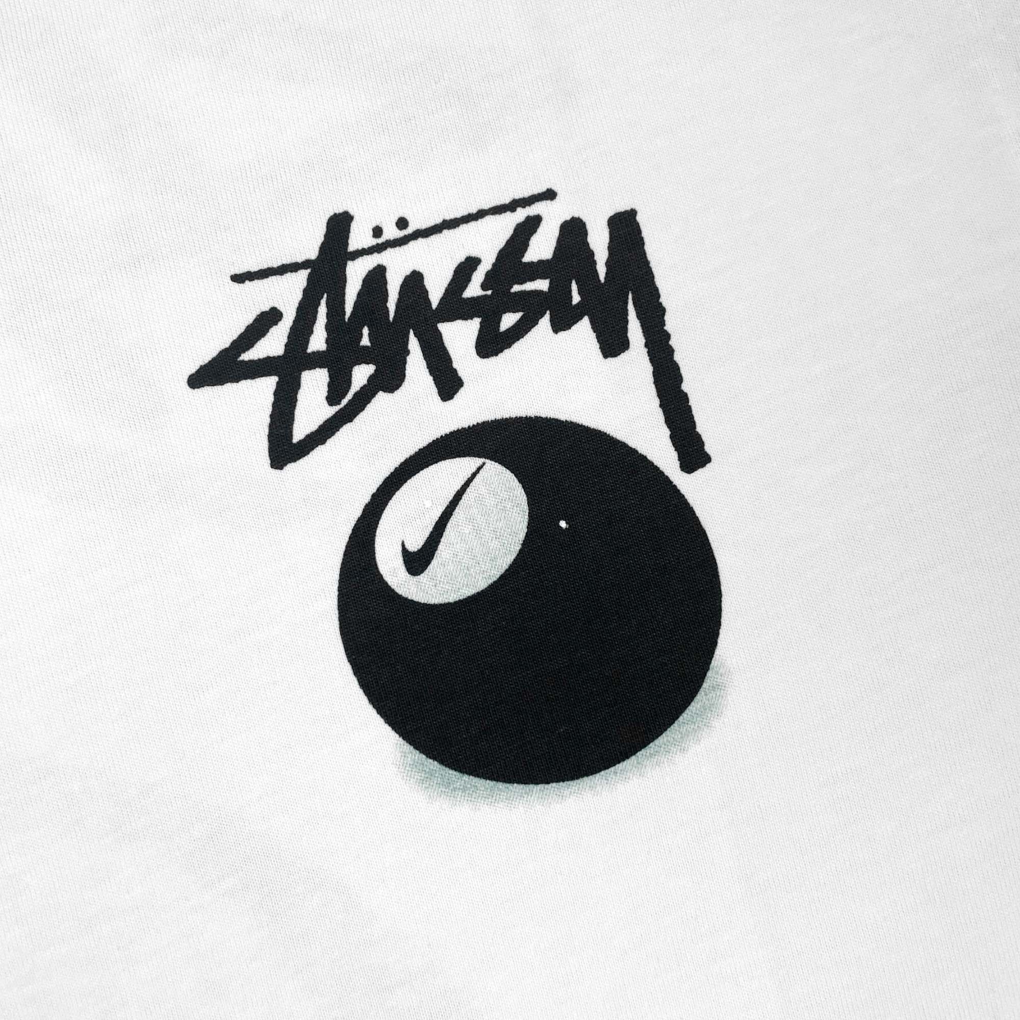 White NIKE X STUSSY 8 Ball T-shirt featuring a bold graphic design on the front.