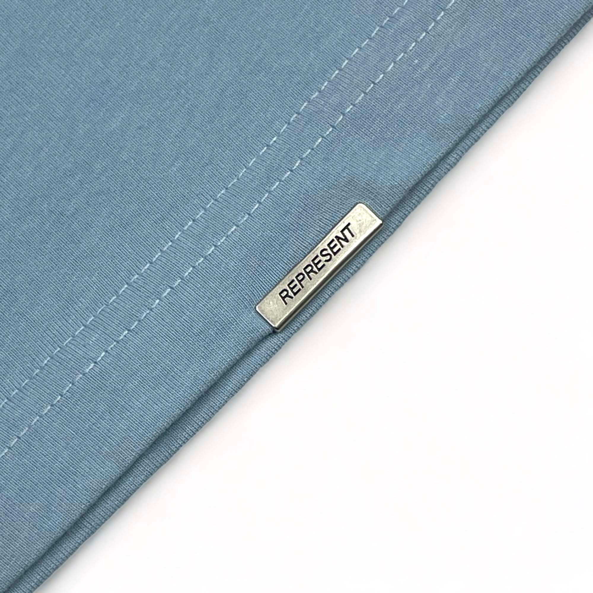 Powder blue REPRESENT OWNERS CLUB T-shirt featuring a relaxed fit and logo design from central.ae.