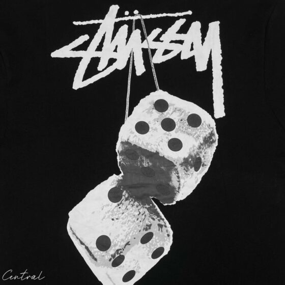 Black Stussy Fuzzy Dice Tee featuring a unique graphic design on a relaxed-fit t-shirt.