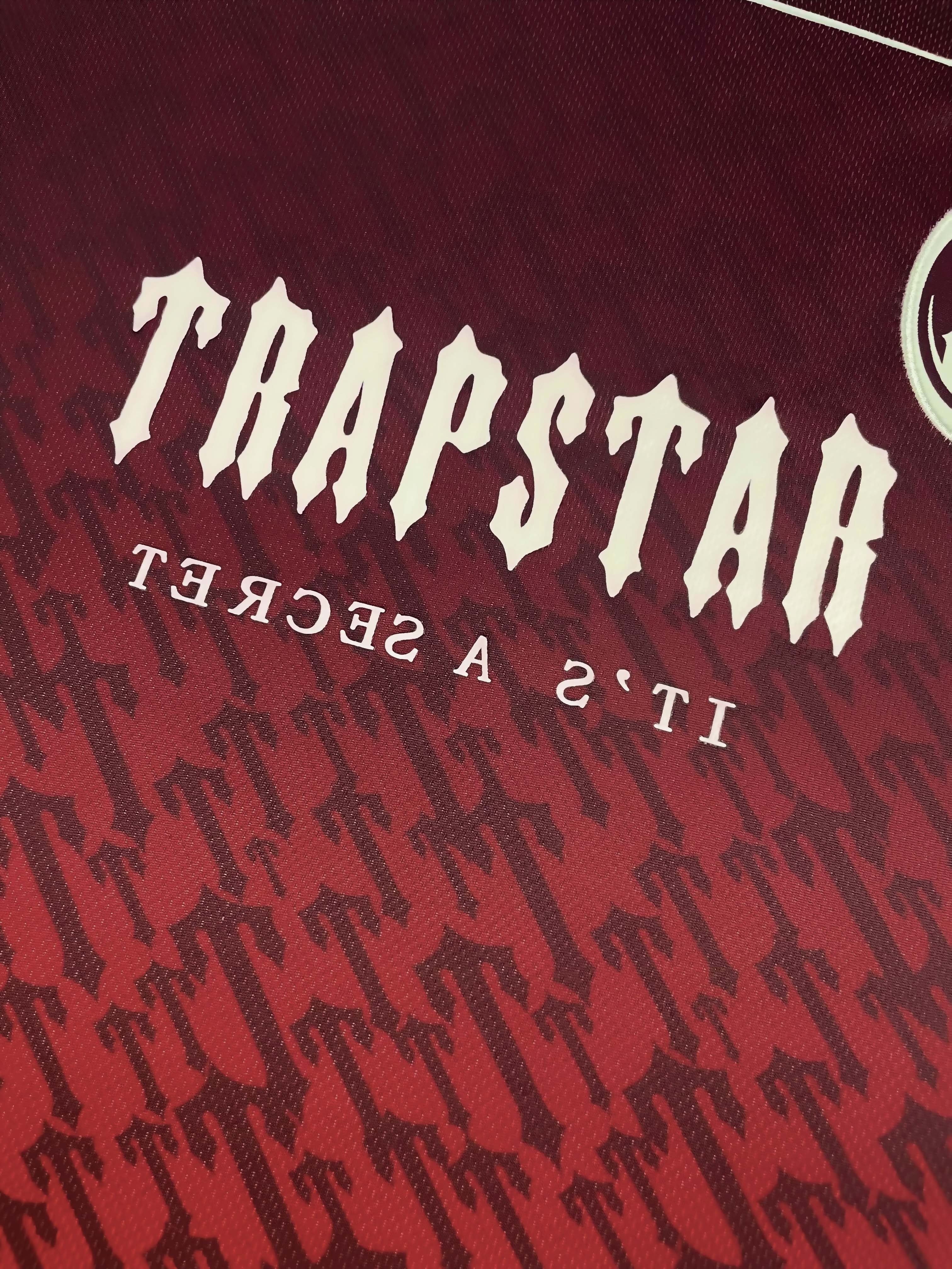 Red gradient Trapstar monogram jersey t-shirt featuring a stylish design and logo detail.