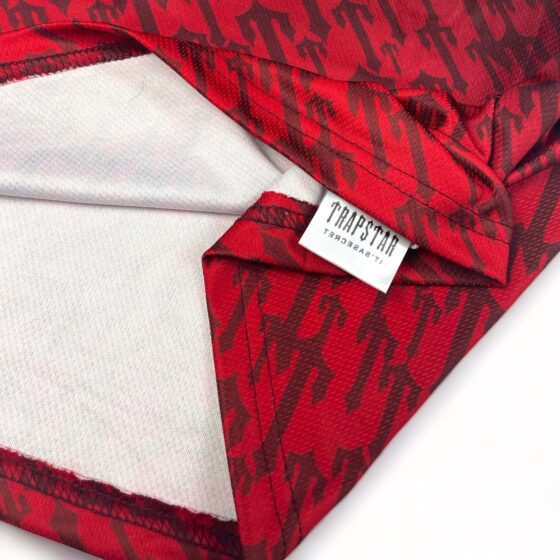 Red gradient Trapstar monogram jersey t-shirt featuring a bold logo design and relaxed fit.