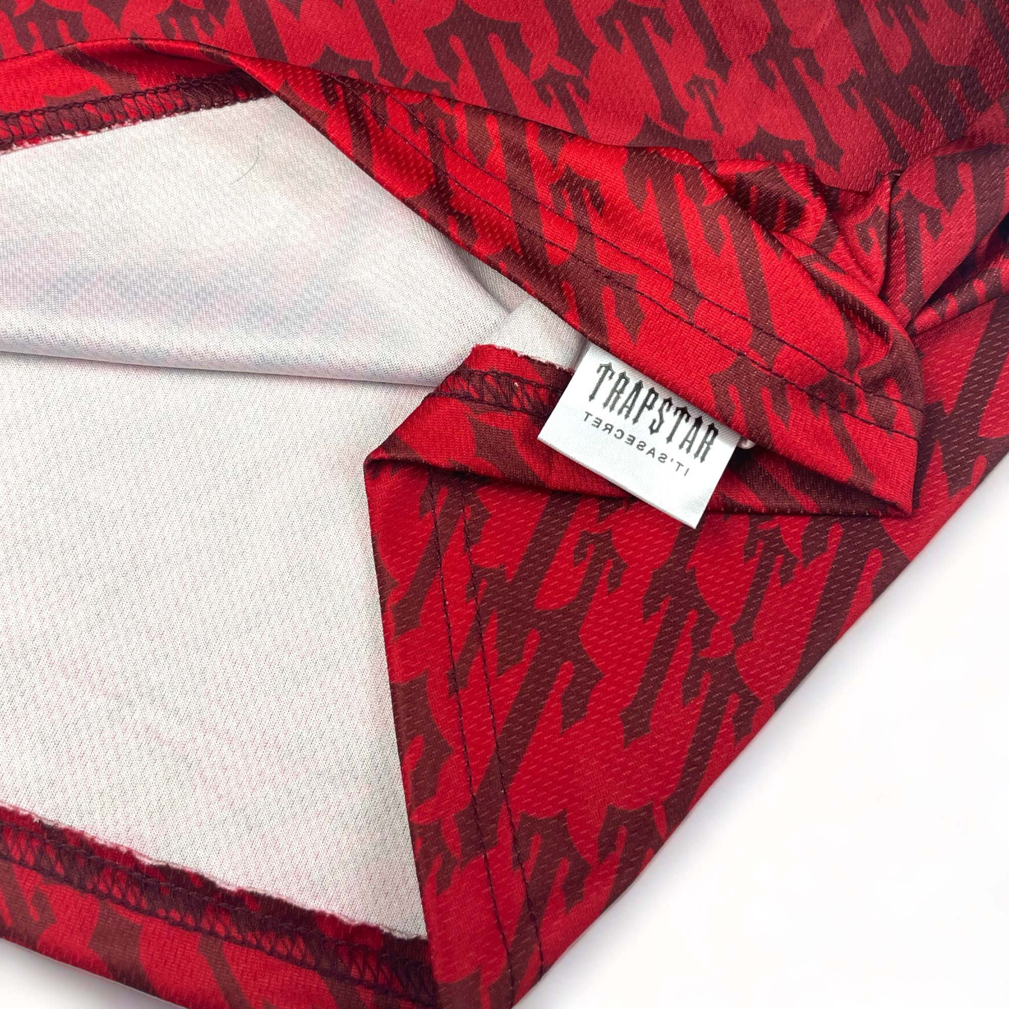 Red gradient Trapstar monogram jersey t-shirt featuring a bold logo design and relaxed fit.