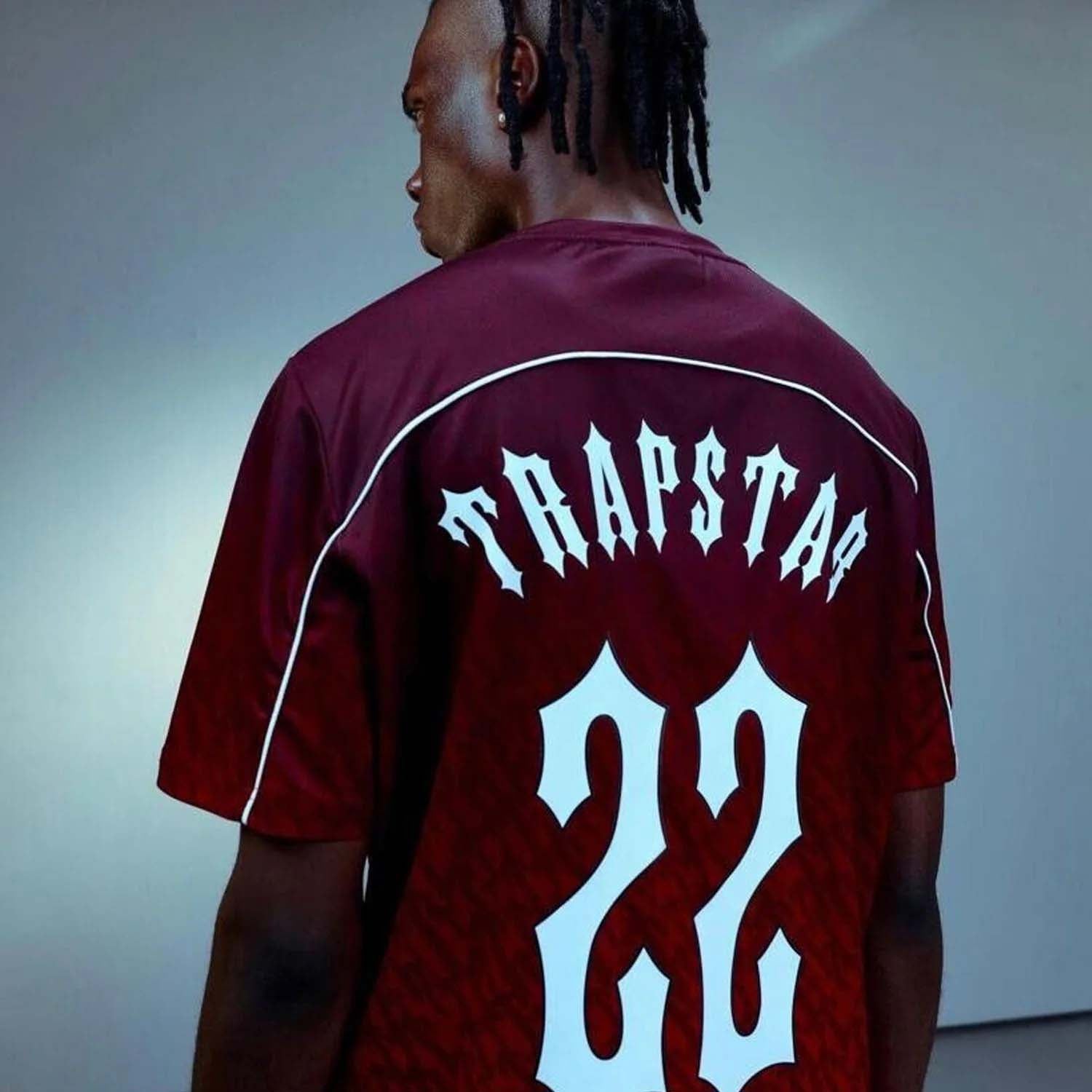 Red gradient Trapstar Monogram jersey t-shirt featuring bold logo design and stylish athletic cut.