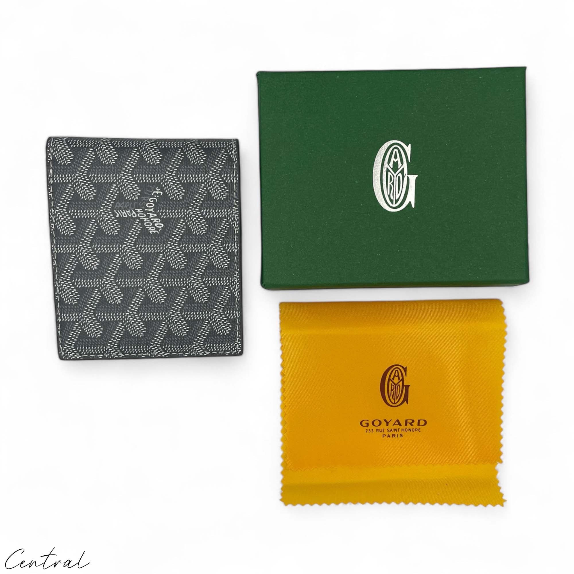 Gray Goyard wallet by Central ae, featuring a sleek design and signature logo pattern on premium material.