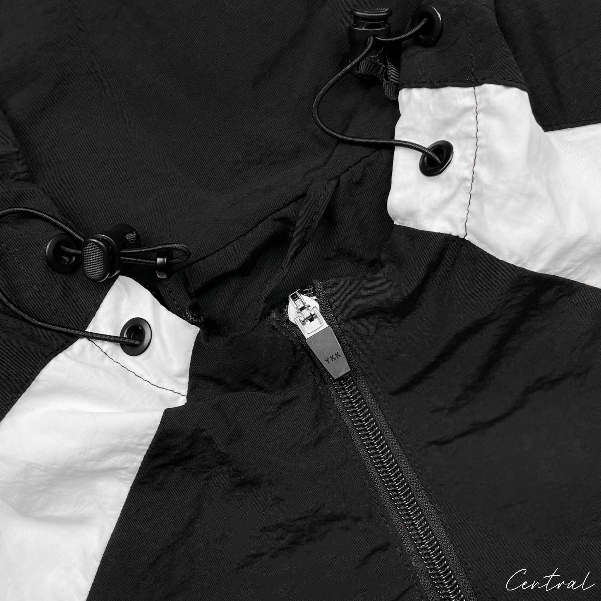 Black Corteiz hoodie featuring a spring design with a front zipper and adjustable hood. Ideal for casual wear.