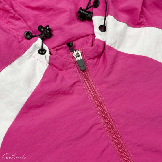 Pink Corteiz hoodie jacket displayed on a hanger, showcasing its stylish design and cozy fabric.