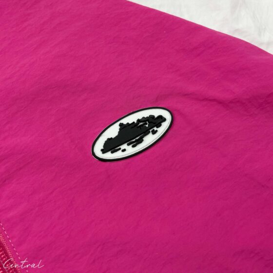 Central Corteiz pink hoodie spring jacket displayed on a hanger with a soft fabric texture and casual style.