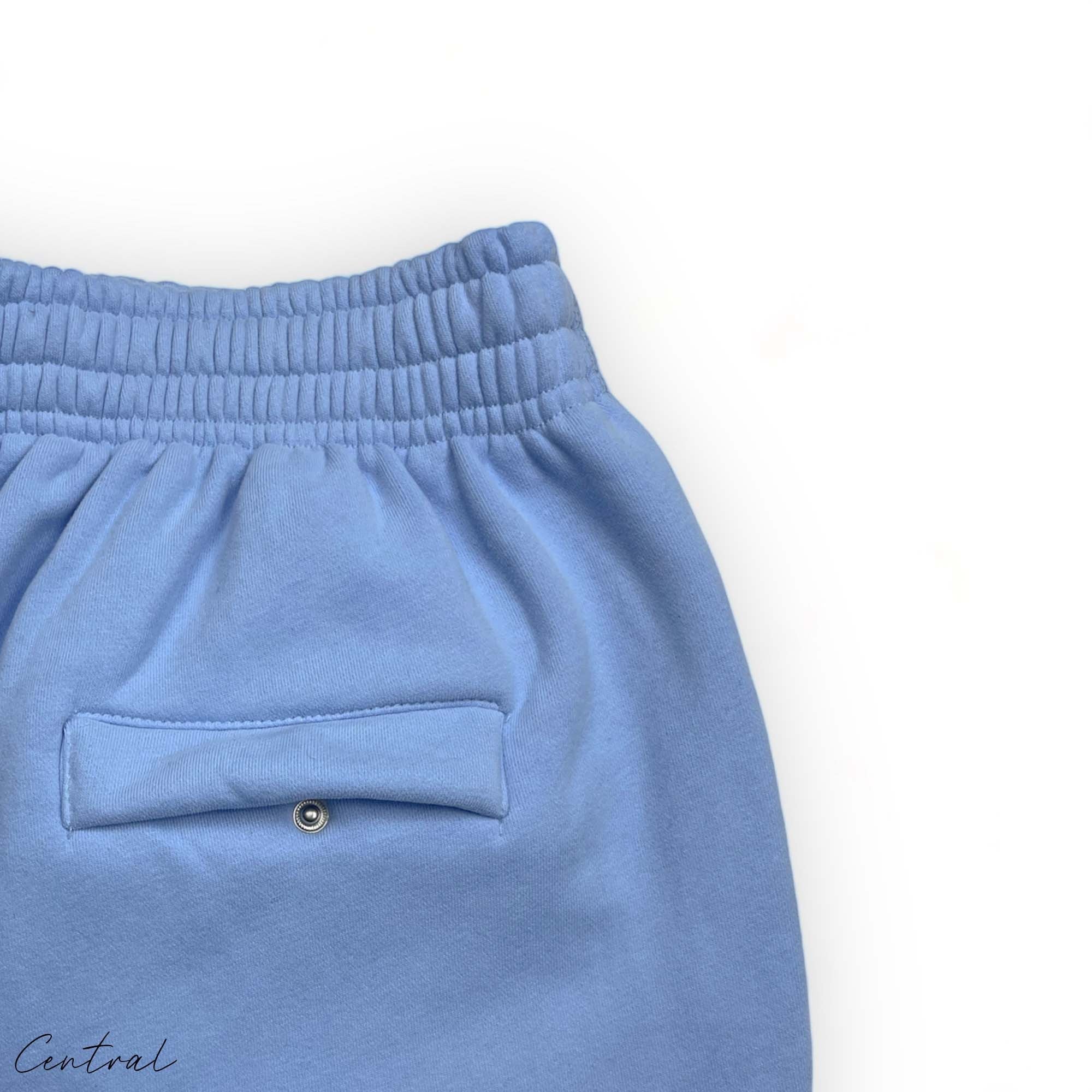 Corteiz Alcatraz baby blue sweatpants featuring a relaxed fit and central logo detail.