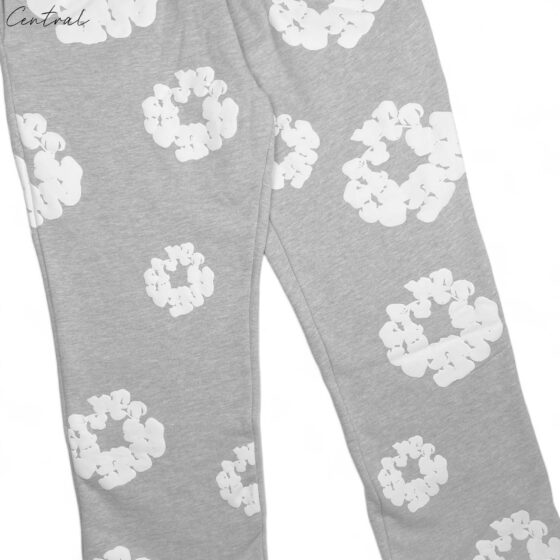 Gray READYMADE x DENIM TEARS sweatpants featuring a relaxed fit and logo detail, displayed on a neutral background.